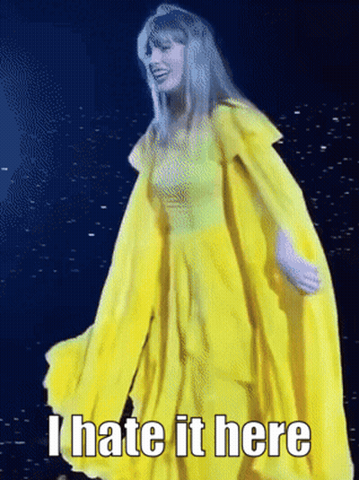 A Woman In A Yellow Dress With The Words " I Hate It Here " On The Bottom GIF