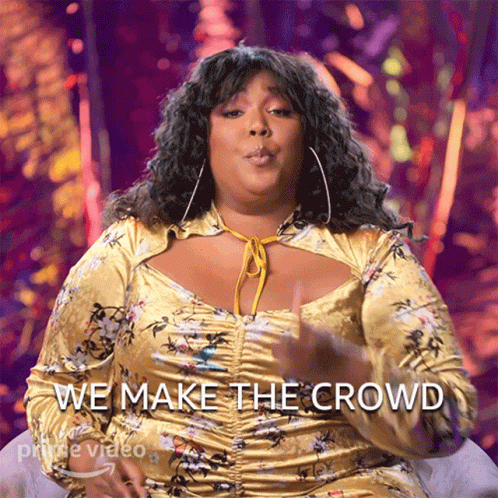 A Woman In A Yellow Floral Dress Says " We Make The Crowd " GIF