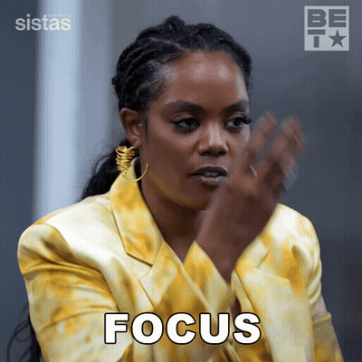 A Woman In A Yellow Jacket Has The Word Focus Written On Her Face GIF