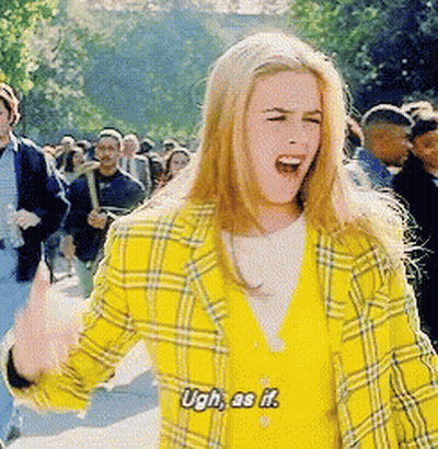 A Woman In A Yellow Plaid Jacket Says Ugh As If In Front Of A Crowd GIF