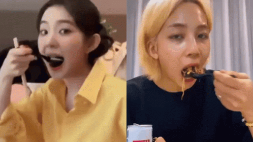 A Woman In A Yellow Shirt Is Eating Noodles With A Fork . GIF