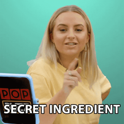 A Woman In A Yellow Shirt Is Pointing At A Screen That Says Pop Secret Ingredient GIF