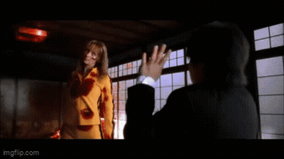 A Woman In A Yellow Shirt Is Saying Go Home To Your Mother . GIF