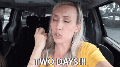 A Woman In A Yellow Shirt Is Sitting In A Car And Says Two Days !!! GIF