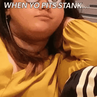 A Woman In A Yellow Shirt Is Sitting On A Couch With A Caption That Says When Yo Pits Stank ... GIF