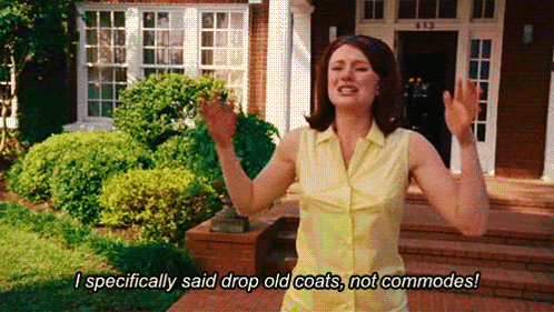 A Woman In A Yellow Shirt Is Standing In Front Of A House Saying I Specifically Said Drop Old Coats , Not Commodes GIF
