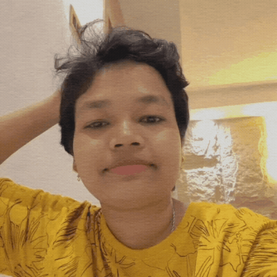 A Woman In A Yellow Shirt Is Taking A Picture GIF