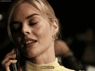 A Woman In A Yellow Shirt Is Talking On A Cell Phone And Says Jesus Christ . GIF