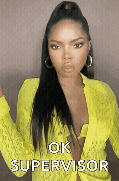 A Woman In A Yellow Shirt Says Ok Supervisor On The Screen GIF