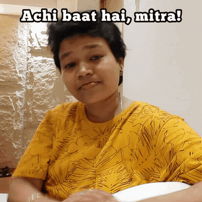 A Woman In A Yellow Shirt With The Words Achi Baat Hai Mitra GIF