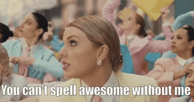 A Woman In A Yellow Suit And Tie Says " You Can 'T Spell Awesome Without Me " In Front Of A Crowd Of People GIF