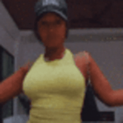 A Woman In A Yellow Tank Top And A Black Hat Is Standing With Her Arms Outstretched . GIF