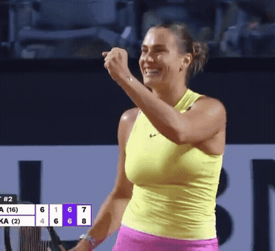 A Woman In A Yellow Tank Top Is Holding A Tennis Racket GIF