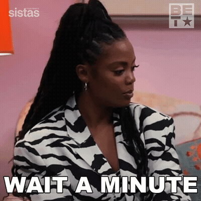 A Woman In A Zebra Print Jacket Is Sitting On A Couch . GIF
