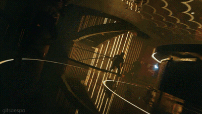 A Woman In A Zebra Print Top Is Kneeling Down In A Dark Room With The Words Gifsresoo Below Her GIF