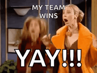 A Woman In An Orange Coat Says " My Team Wins Yay !! " GIF