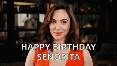 A Woman In An Orange Dress Says Happy Birthday Senorita GIF