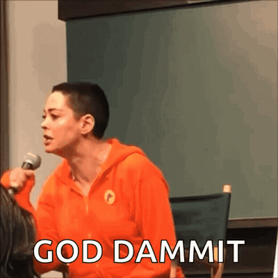 A Woman In An Orange Hoodie Is Holding A Microphone And The Words God Dammit Are Above Her GIF