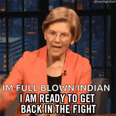 A Woman In An Orange Jacket Is Saying I 'M Full Blown Indian I Am Ready To Get Back In The Fight . GIF