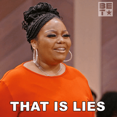 A Woman In An Orange Shirt With The Words That Is Lies On The Bottom GIF