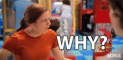 A Woman In An Orange Striped Shirt Is Asking Why In An Arcade . GIF