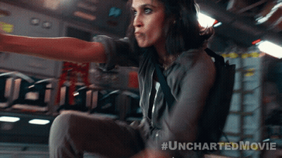 A Woman In An Uncharted Movie Is Sitting On A Plane GIF