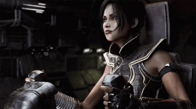 A Woman In Armor Is Sitting In A Chair Holding A Gun GIF