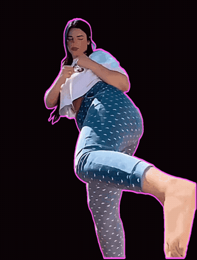 A Woman In Blue Polka Dot Pants And A White Shirt Is Standing On One Leg GIF