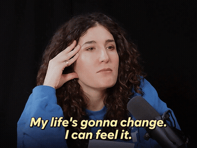 A Woman In Front Of A Microphone Says " My Life 'S Gonna Change .. I Can Feel It " GIF