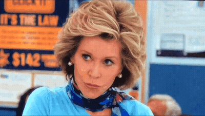 A Woman In Front Of A Sign That Says It 'S The Law $ 1482 GIF