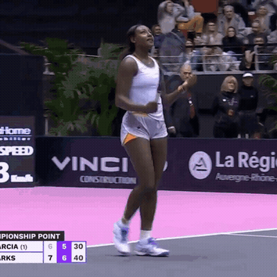 A Woman In Shorts Is Walking On A Tennis Court GIF