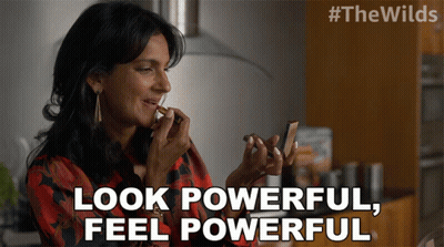 A Woman Is Applying Lipstick And The Words Look Powerful Feel Powerful Are Above Her GIF
