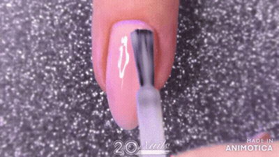 A Woman Is Applying Nail Polish To Her Nails With A Nail Brush . GIF