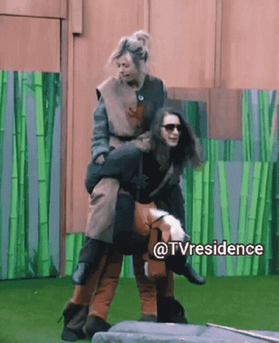 A Woman Is Being Carried On The Back Of Another Woman In A Tv Residence Scene GIF