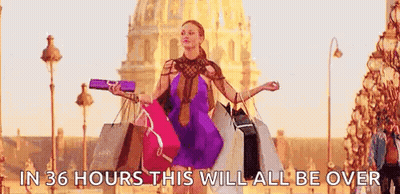 A Woman Is Carrying A Bunch Of Shopping Bags On A Street . GIF