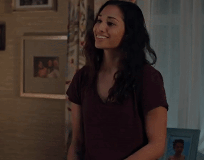 A Woman Is Clapping Her Hands In A Living Room In Front Of A Window . GIF
