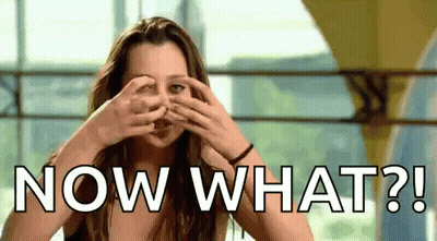 A Woman Is Covering Her Eyes With Her Hands And The Words Now What ? GIF