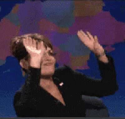 A Woman Is Covering Her Eyes With Her Hands In Front Of A Map GIF