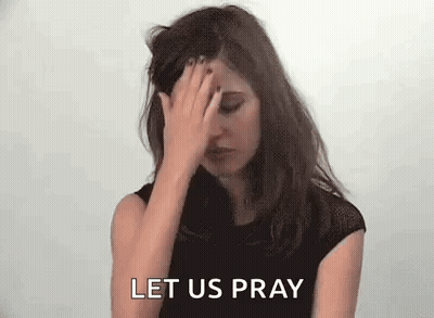 A Woman Is Covering Her Face With Her Hand And The Words `` Let Us Pray '' Are Behind Her . GIF