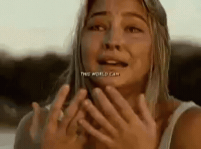 A Woman Is Covering Her Face With Her Hands And Making A Funny Face . GIF