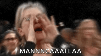 A Woman Is Covering Her Face With Her Hands While Screaming In A Crowd Of People . GIF