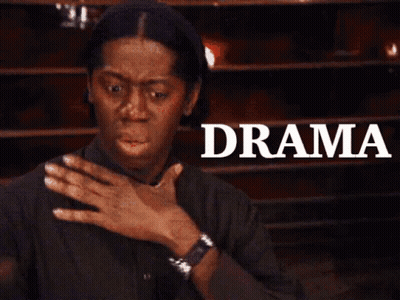 A Woman Is Covering Her Mouth In Front Of A Sign That Says " Drama " GIF