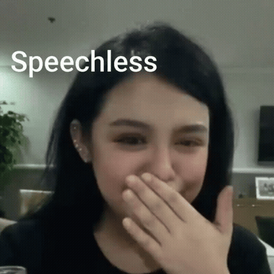 A Woman Is Covering Her Mouth With Her Hand And The Words Speechless Are Above Her Head GIF