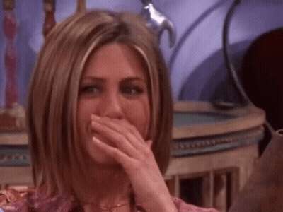A Woman Is Covering Her Mouth With Her Hand While Laughing GIF