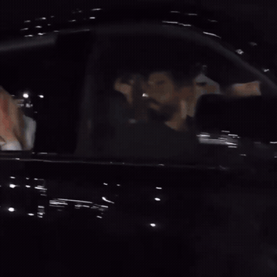 A Woman Is Covering Her Mouth With Her Hand While Sitting In A Car GIF