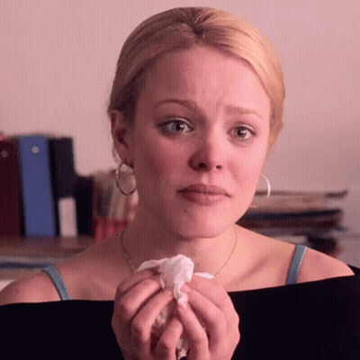 A Woman Is Crying And Holding A Napkin In Her Hand GIF