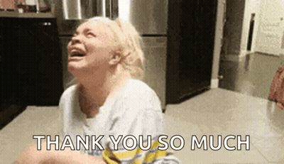 A Woman Is Crying And Saying `` Thank You So Much '' While Sitting On The Floor . GIF
