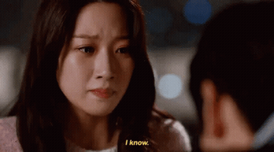 A Woman Is Crying And Talking To Another Woman While A Man Looks On . GIF