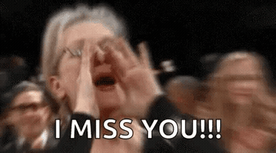 A Woman Is Crying In A Crowd Of People While Holding Her Hands To Her Face . GIF