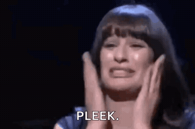 A Woman Is Crying On A Stage While Holding Her Hands To Her Chest . GIF